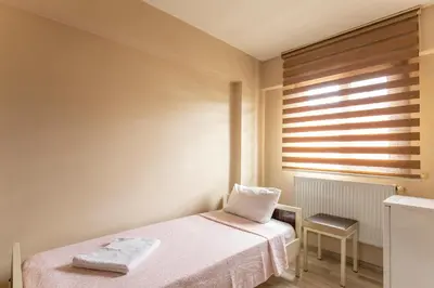 a small bedroom with a bed and a window at Beyoglu Huzur Hotel in Istanbul