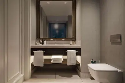 a bathroom with a sink and a toilet and a mirror at Ramada Plaza By Wyndham Sultanahmet in Istanbul