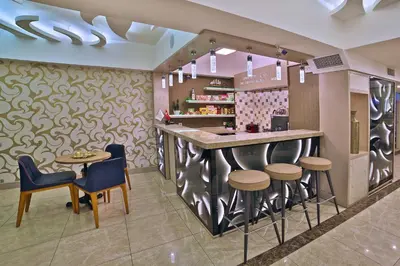 a bar in a restaurant with stools and a counter at Hotel Resitpasa Istanbul in Istanbul