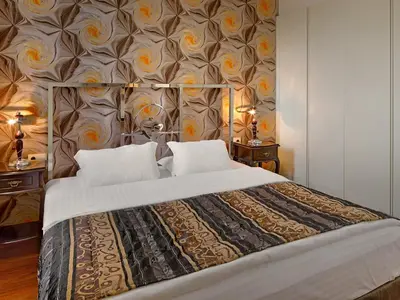 a bedroom with a large bed with a floral wallpaper at Galateia Residence in Istanbul