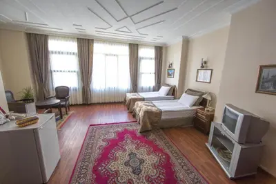 a living room with a couch and a tv at Villa Sofia in Istanbul