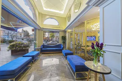 a lobby with blue benches and a table with flowers at History Hotel in Istanbul