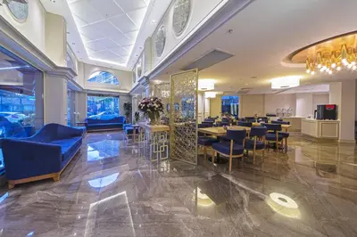 a restaurant with blue chairs and tables in a room at History Hotel in Istanbul