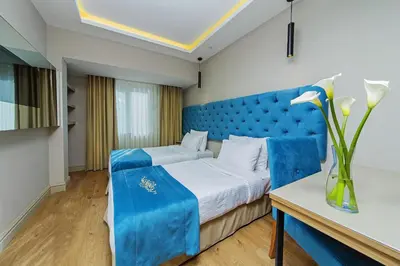 a blue bedroom with a bed with a blue headboard at History Hotel in Istanbul