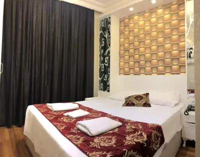 a bedroom with a bed with two towels on it at Art City Hotel Istanbul in Istanbul