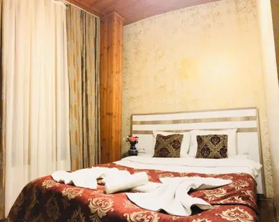 a bedroom with a bed with white sheets and pillows at Art City Hotel Istanbul in Istanbul