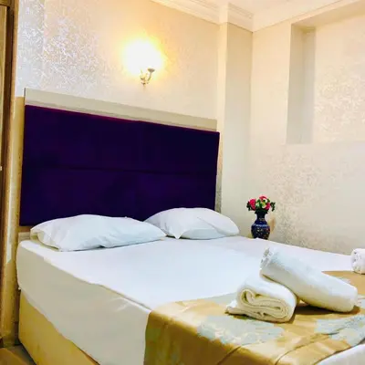 a bed with two towels sitting on top of it at Art City Hotel Istanbul in Istanbul