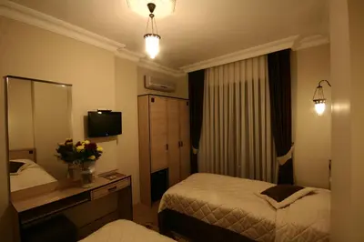 a hotel room with two beds and a mirror at Art City Hotel Istanbul in Istanbul