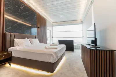 a bedroom with a large bed and a television at Golden Pars Hotel in Bursa