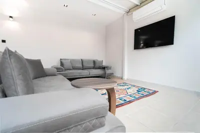 a living room with a couch and a tv at Golden Pars Hotel in Bursa