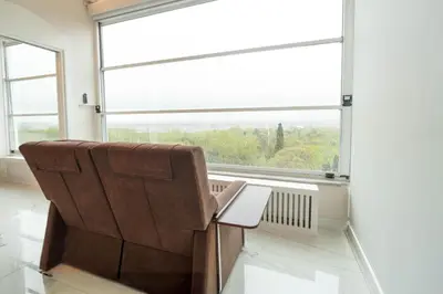 a chair in a room with a large window at Golden Pars Hotel in Bursa