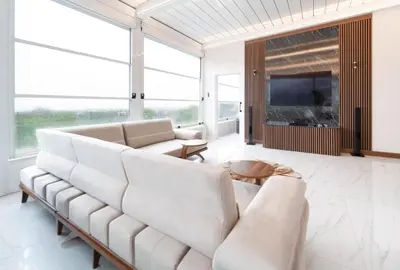 a living room with white furniture and large windows at Golden Pars Hotel in Bursa