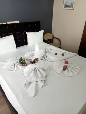 a white bed with white towels on it at Hotel Cesmeli in Bursa