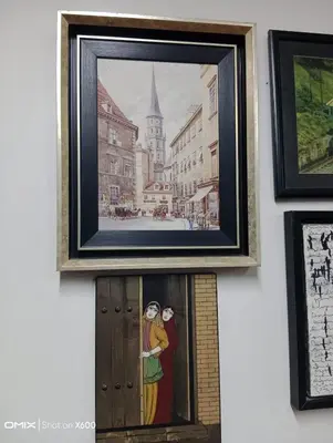 a picture of two people in a picture frame on a wall at Hotel Cesmeli in Bursa