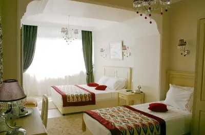 a hotel room with two beds and a window at Divas Hotel in Istanbul