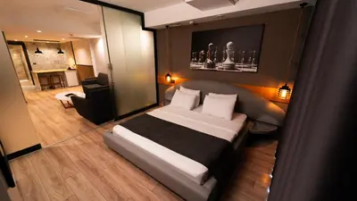a bedroom with a bed and a living room at Mas Suites Nisantasi in Istanbul