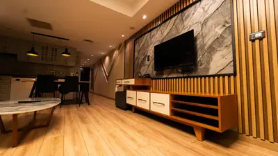 a living room with a flat screen tv on a wall at Mas Suites Nisantasi in Istanbul