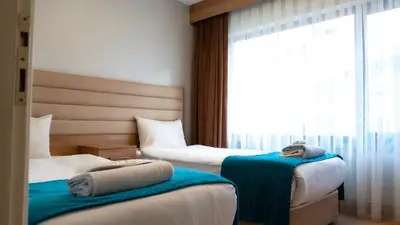 a hotel room with two beds and a window at Bursa Suites Apart Otel in Bursa