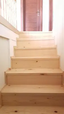 a staircase with wooden steps leading to a door at Charming Anatolian House in Çengelköy in Istanbul