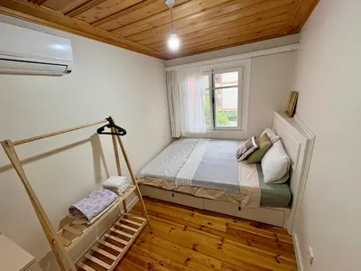 a small bedroom with a bed and a window at Charming Anatolian House in Çengelköy in Istanbul