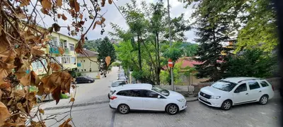two white cars parked on the side of a street at Charming Anatolian House in Çengelköy in Istanbul