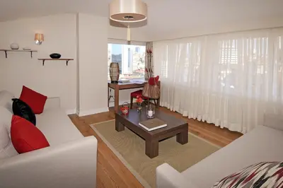 a living room with a couch and a table at Cheya Sisli BNB Medical & Business City Center Tesvikiye Suites and Apartments in Istanbul