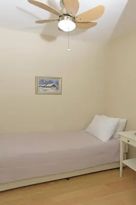 a bedroom with a bed with a ceiling fan at Cheya Sisli BNB Medical & Business City Center Tesvikiye Suites and Apartments in Istanbul