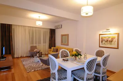 a living room with a white table and chairs at Cheya Taksim BNB Gumussuyu Istanbul City Center Comfort Residence in Istanbul