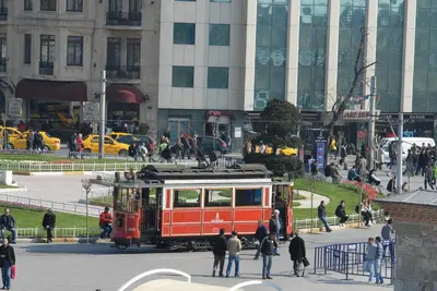 a trolley car in a city with people walking around at Cheya Taksim BNB Gumussuyu Istanbul City Center Comfort Residence in Istanbul