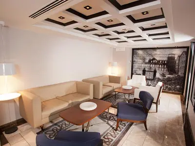 a living room with a couch and a table and chairs at Hotel La Villa in Istanbul