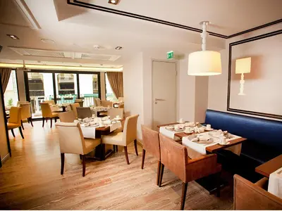 a restaurant with tables and chairs in a room at Hotel La Villa in Istanbul