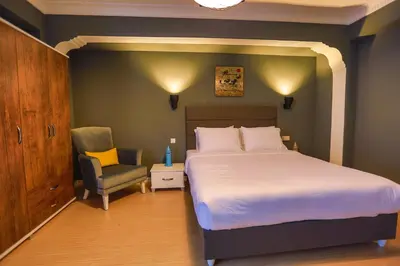 a bedroom with a bed and a chair at Flats Company - Karakoy Apartment in Istanbul