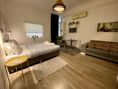 a living room with a bed and a couch at Flats Company - Karakoy Apartment in Istanbul