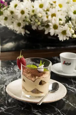 a cup of dessert with a strawberry on a plate at Nabu Hotel Karaköy in Istanbul