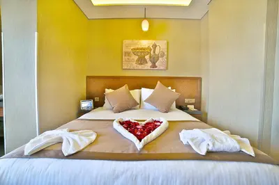 a bedroom with a bed with a heart shaped pillow at Corner Hotel Laleli in Istanbul