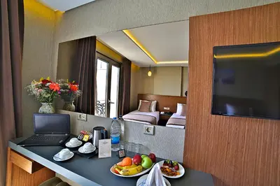 a hotel room with a table with food and a television at Corner Hotel Laleli in Istanbul