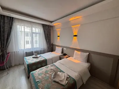 a hotel room with two beds and a window at Fly Hotel in Istanbul
