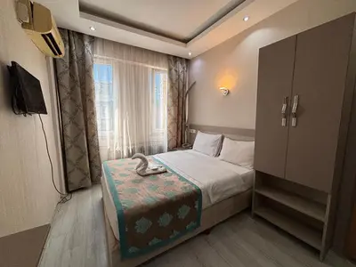 a small bedroom with a bed and a window at Fly Hotel in Istanbul
