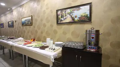a row of tables in a restaurant with food at Fly Hotel in Istanbul