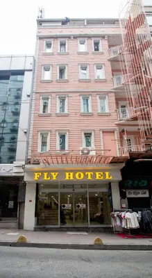 a pink building with a try hotel sign in front of it at Fly Hotel in Istanbul