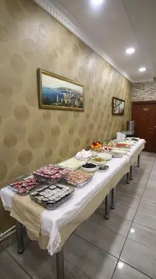 a long table with many plates of food on it at Fly Hotel in Istanbul