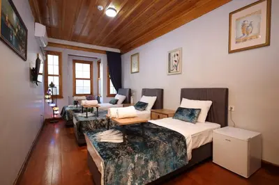 a living room with two beds and a couch at The Trip istanbul Hotel in Istanbul