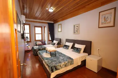 a bedroom with two beds and a couch at The Trip istanbul Hotel in Istanbul