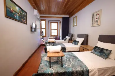 a hotel room with two beds and a couch at The Trip istanbul Hotel in Istanbul