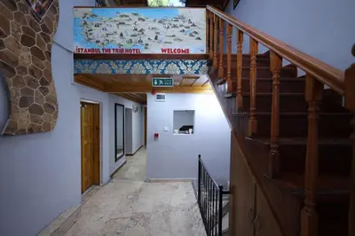 a hallway with a staircase with a sign on the ceiling at The Trip istanbul Hotel in Istanbul