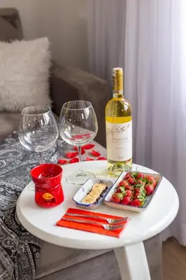 a white table with a bottle of wine and wine glasses at Sadaret Hotel-Old City Sultanahmet in Istanbul