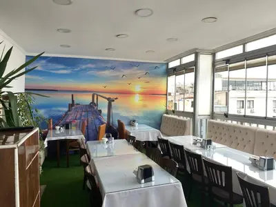 a restaurant with tables and chairs with a painting on the wall at Polanin Hotel in Istanbul