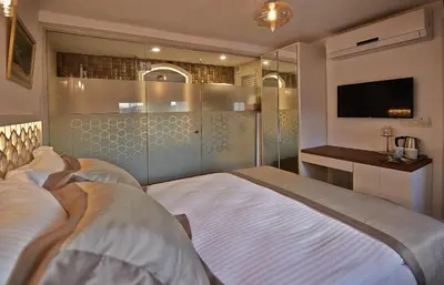 a bedroom with a large bed and a television at Arart Hotel in Istanbul