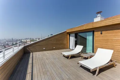 a balcony with two white chairs on a roof at The Wings Hotels Collection in Istanbul