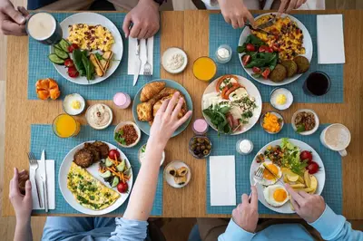 a group of people sitting around a table with food at The Wings Hotels Collection in Istanbul